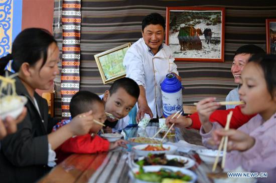 A villager serves water for guests in Gaxiu Village of Gahai Township, Luqu County, Gannan Tibetan Autonomous Prefecture, northwest China's Gansu Province, Aug. 13, 2019. In recent years, Gannan promoted culture and tourism industry to boost income of local people. (Xinhua/Chen Bin)